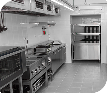 Professional kitchen with appliances, cooking stations, and storage shelves after a thorough deep kitchen cleaning.