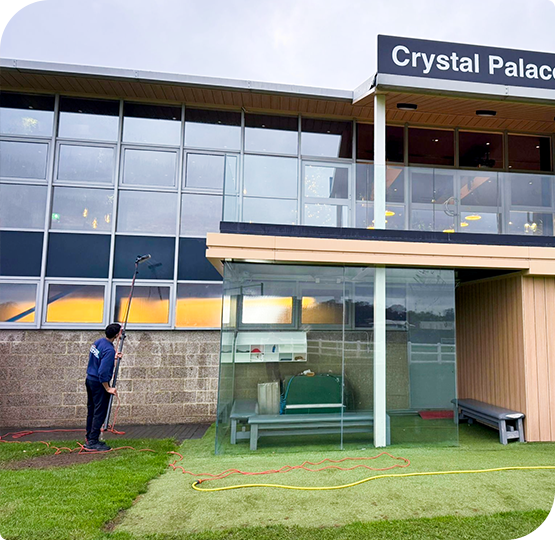Fantastic Services technician carrying out commercial window cleaning at Crystal Palace FC training ground