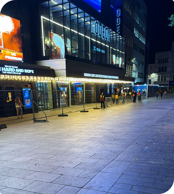 ODEON Luxe Leicester Square entrance at night after an event, with barriers and security staff outside
