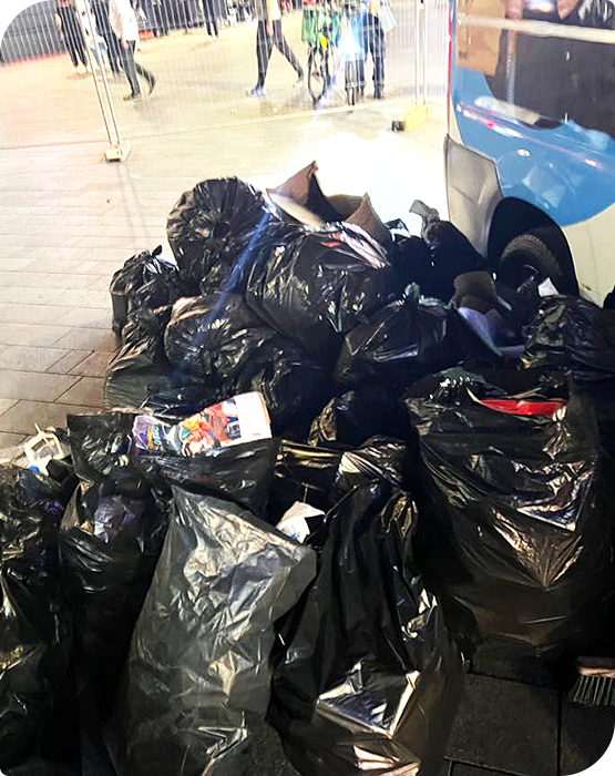 Black rubbish bags collected for a commercial waste removal service after an event in London.