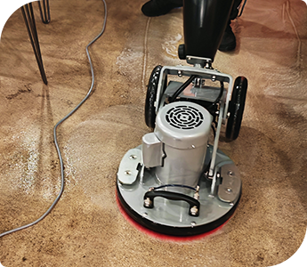 hard-floor scrubbing-d Floor cleaning machine removing dirt and grime during commercial hard floor cleaning