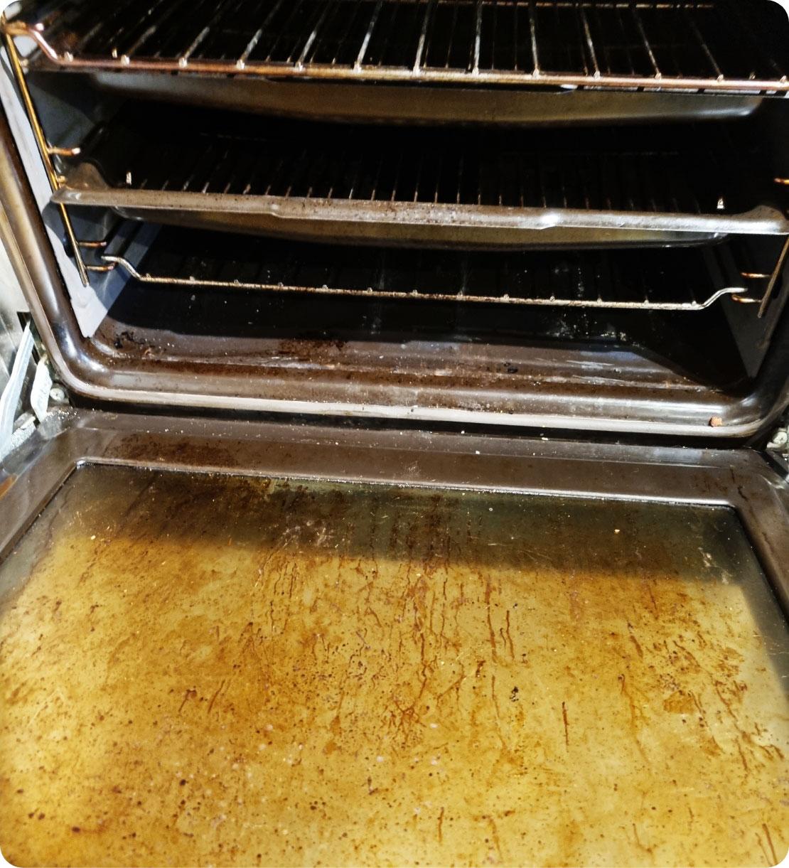 The image shows a dirty oven before cleaning.