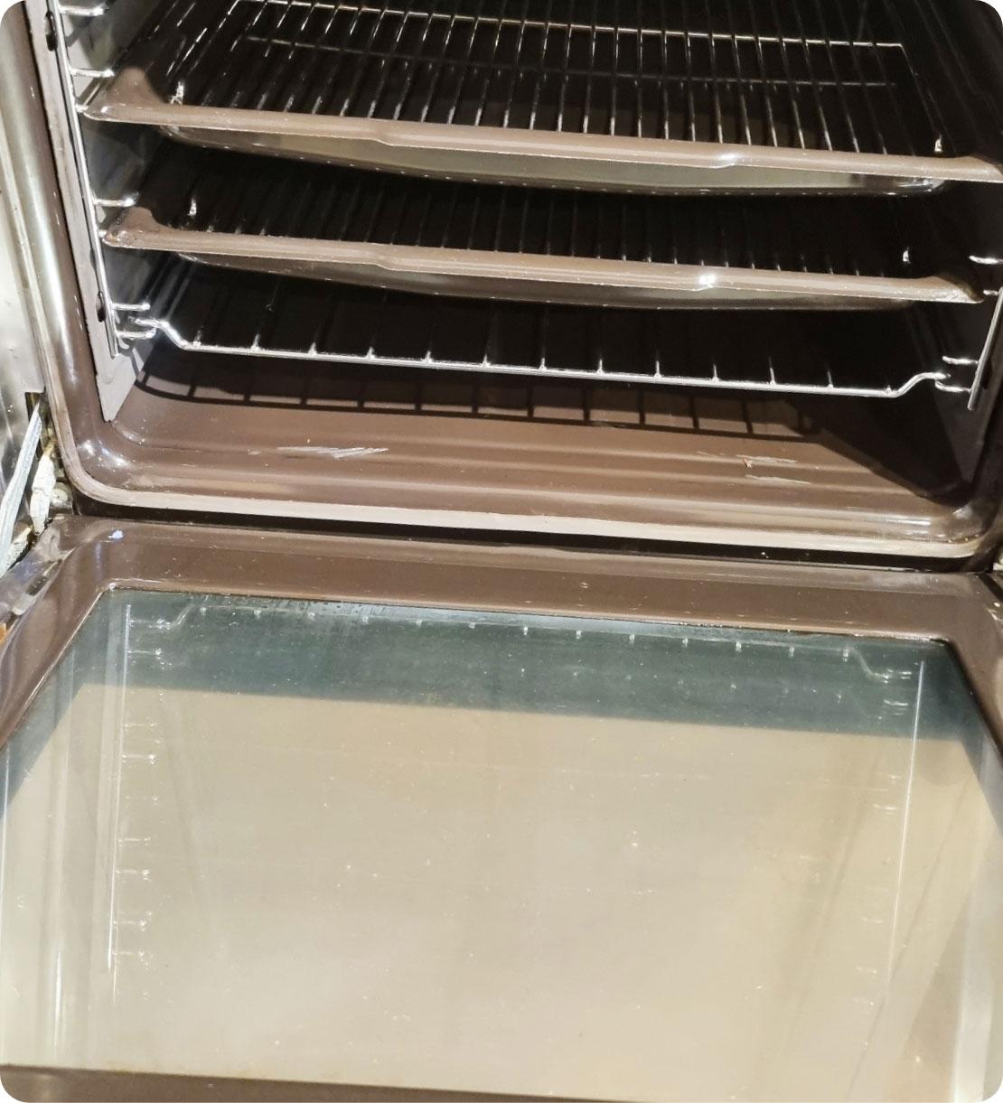 The image shows a sparkling clean oven after being clean by a Fantastic Service professional.