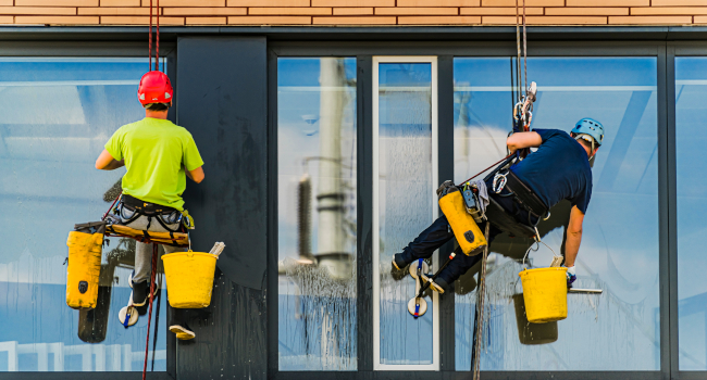 Professionals cleaning the windows of a commercial building