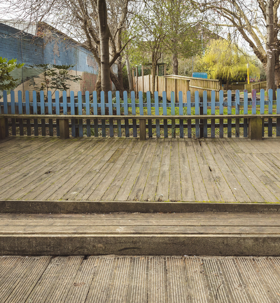 wooden-deck-playground-maintenance-after Wooden deck area in a children’s playground after professional maintenance