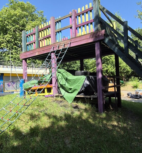 climbing-frame Outdoor wooden climbing frame with colourful railings and rope net