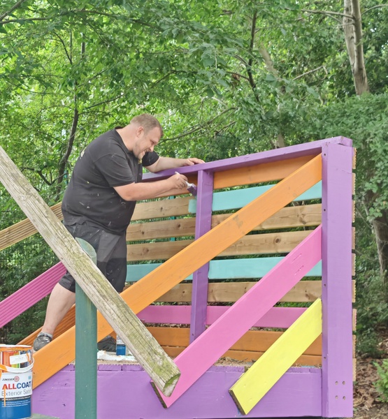 colourful-platform-painting Fantastic Services Commercial handyman painting a colourful wooden playground platform during Lady Allen Adventure Playground ongoing refurbishment programme.