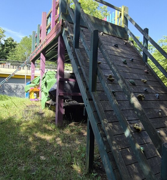 lady-allen-playground-climbing-wall Wooden climbing wall and raised play platform