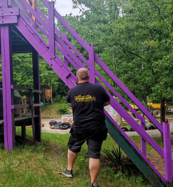 lady-allen-playground-purple-staircase-painting Fantastic Services Commercial handyman painting a purple wooden staircase during the refurbishment of Lady Allen Adventure Playground.