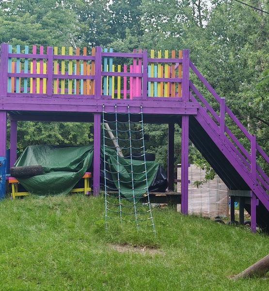 purple-play-structure Colourfully repainted wooden play structure