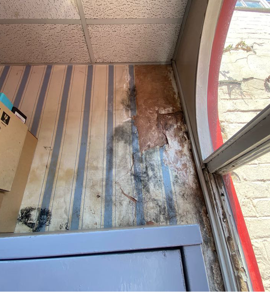 mould-damage-around-window-and-wall Mould growth and damp damage around an interior window frame and adjoining wall