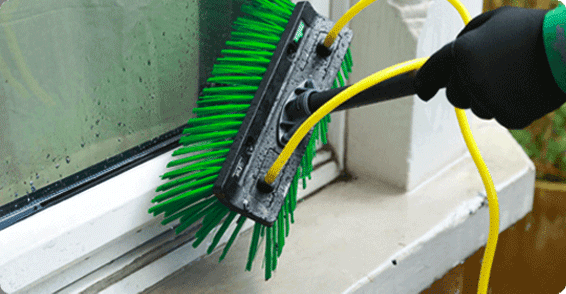 A man cleaning a window frame